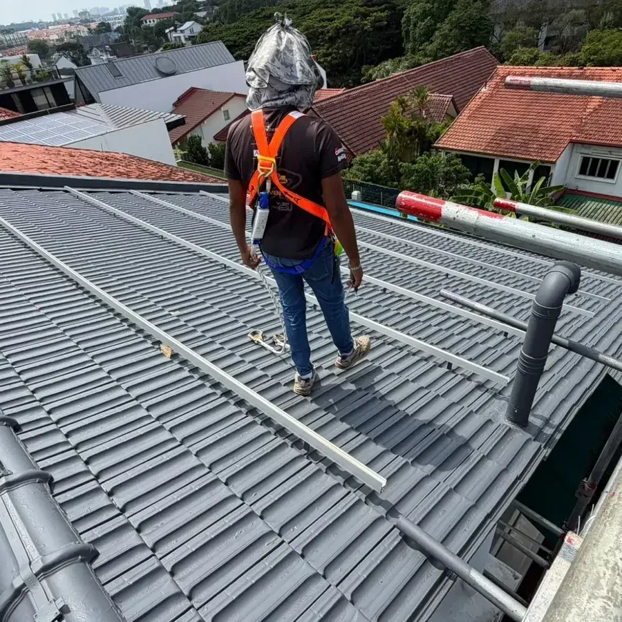 Grey roof coating applied over the entire tiled roof of a landed home